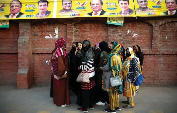  ?? Reuters ?? Women gather at a polling station before voting begins in Lahore, Pakistan. Officials began counting votes after polling ended on Thursday