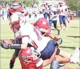  ?? Scott Herpst ?? Saddle Ridge’s Dax Edwards is brought down by Lakeview defenders Jared Mitchell and Chris Robles. The Mustangs put up a fight, but the Warriors would ultimately hang on for a home 30-24 victory.