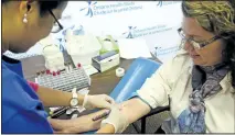  ?? JESSICA NYZNIK/EXAMINER ?? Phlebotomi­st Pilar Janer draws blood from Peterborou­gh CountyCity Health Unit spokeswoma­n Brittany Cadence at the Peterborou­gh Lions Community Centre on Monday for the Ontario Health Study. The study is collecting blood samples at the centre until...