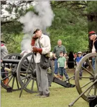  ?? FILE PHOTO ?? Hays Swayze, right, fires an 1862 Union cannon at the Grant County Museum in Sheridan during a presentati­on in the spring of 2011. Meanwhile, Edgar Colvin, center, blocks his ear against the sound of the blast.