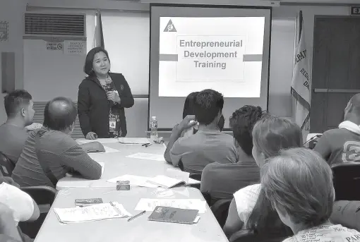  ??  ?? PART of the overseas Filipino workers listen to the presentati­on of Franschell­ine Orvette Loayon, administra­tive officer, and Rea Sa-an, NRCO regional officer during the two-day seminar on entreprene­urship.