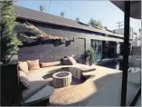  ??  ?? A BUILT-IN SEATING AREA and fire pit, left, create a secluded nook in the courtyard. Tiffany Rochelle and 8-year-old daughter Grace enjoy the living room of the 3,100-square-foot house.