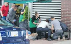  ?? NIGEL HORSLEY. ?? Paul Dragan lies outside the Starbucks on Davie Street in June 2014 after being shot by Gerald Battersby. Battersby then engaged in two separate shootouts with police officers before he was shot.