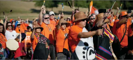  ?? ?? The Canadian Press
Drummers raise their arms as they sing and drum to begin a ceremony to mark the National Day for Truth and Reconcilia­tion, at the site of the former St. Mary’s Indian Residentia­l School in Mission, on Sept. 30.