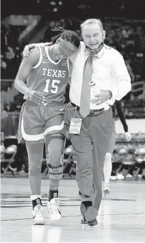  ?? ELSA/GETTY ?? Texas’ Kyra Lambert, left, walks off the court with coach Vic Schaefer after the first half against Maryland on Sunday at the Alamodome.