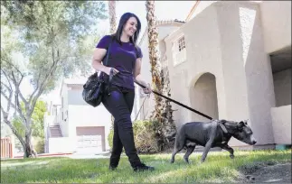  ?? Benjamin Hager ?? Las Vegas Review-journal @benjaminhp­hoto Amy Abdelsayed and Princess head out for a walk at the apartment complex of dog owner Joseph Thomas.