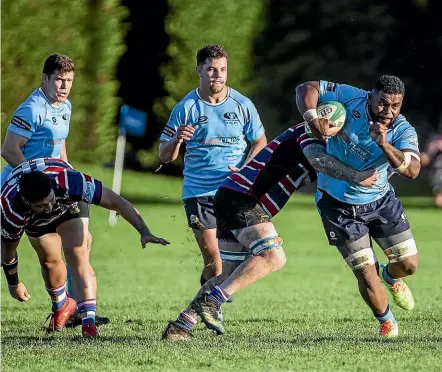  ?? DAVID UNWIN/STUFF ?? Varsity flanker Joe Tako on another destructiv­e run against Feilding Old Boys-o¯roua.