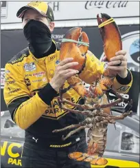  ?? CHARLES KRUPA — THE ASSOCIATED PRESS ?? Rochester Hills native Brad Keselowski holds a giant lobster to celebrate his victory in Sunday’s NASCAR Cup Series race at the New Hampshire Motor Speedway, his third victory this year.