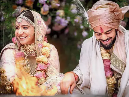  ?? — AFP ?? Elegant couple: This handout picture released by Yash Raj Films shows Indian cricketer Virat Kohli and Bollywood actress Anushka Sharma performing their wedding ceremony in Buoncovent­o near Siena on Monday.