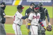  ?? MICHAEL WYKE — THE ASSOCIATED PRESS ?? Atlanta Braves third base coach Ron Washington consoles Ronald Acuna Jr., center, during the third inning in Game 1of the National League Division Series against the Miami Marlins on Tuesday in Houston.