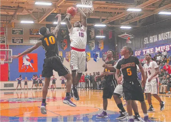  ?? | WORSOM ROBINSON/ FOR THE SUN- TIMES ?? St. Rita forward Stedmon Ihejirika ( 15 points) puts up a shot against Providence- St. Mel’s Jason Mason in the Mustangs’ victory Tuesday.