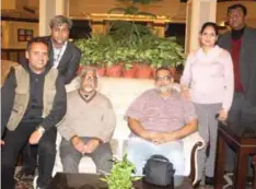  ??  ?? Sayyed Sarfaraz-ud-din (left-standing), Arun Gandhi and Tushar Gandhi (sitting in the centre) with the Travel Passion Inc team