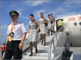  ?? CFP ?? HNA Group aircrew leave a plane after it landed in Zhubi Reef, Hainan province.