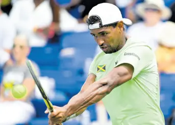  ?? PHOTOS BY RICARDO MAKYN/CHIEF PHOTO EDITOR ?? Jamaica’s Rowland Phillips plays a backhanded return during Davis Cup Group II action at the Eric Bell Tennis Centre on Sunday.