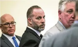  ?? BROOKE LAVALLEY / THE COLUMBUS DISPATCH ?? Former Franklin County Sheriff’s office deputy Jason Meade stands with his defense attorneys, Jan. 31 in Columbus. The retrial of Meade, who is charged with murder in the killing of a Black man, will be held this fall.