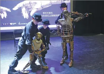  ?? PHOTOS BY ZOU HONG / CHINA DAILY ?? Above: Each puppet is controlled by two actors onstage. Below: Ma Liang (second from right) instructs performers at a rehearsal in Beijing. Right: The puppets are made of thousands of small parts.