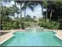  ??  ?? The sparkling pool and spa back up to the golf course at this Mizner Country Club home.