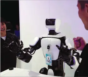  ??  ?? People play rock-paper-scissors with a Toyota T-HR3 humanoid robot at the Tokyo Motor Show, in Tokyo, Japan, on Wednesday. REUTERS