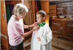  ?? Foto: Emanuel Wersin ?? Das erste Mal als Ministrant wird Raphael Wersin eingekleid­et. Sein Bruder Emanuel hat ihn und Mesnerin Rita Schafroth dabei fotografie­rt.