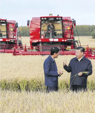  ?? XIE HUANCHI/XINHUA VIA THE ASSOCIATED PRESS ?? President Xi Jinping, right, inspects a farm in China’s northeast. China has said the trading veto clause in the USMCA “interferes with the sovereignt­y of others.”