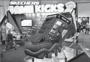  ?? AP ?? Visitors pass by the Skechers’ booth at the Internatio­nal Consumer Electronic­s Show in Las Vegas in January 2016.