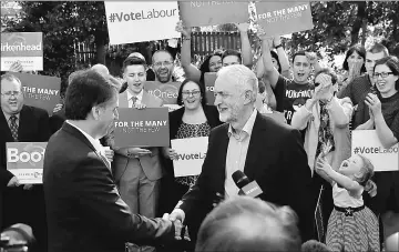  ??  ?? Corbyn shaking hands with the new metropolit­an mayor of Liverpool, Steve Rotherham at an election event in Liverpool, Britain. — Reuters photo