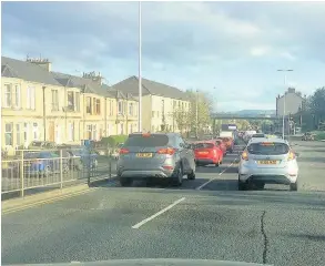  ??  ?? Congestion Traffic on Mill Street is backed up, with drivers saying parked cars on Glasgow Road are the problem