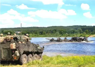  ??  ?? Allied troops cross Neman river during Nato exercise Saber Strike in Kulautuva, Lithuania. — Reuters photo