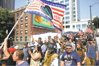  ?? Genna Martin / SeattlePI.com ?? Protesters from right-wing groups Washington 3 Percenters and Patriot Prayer march during a “Liberty or Death” rally at Seattle City Hall to oppose Washington gun-control Initiative 1639.