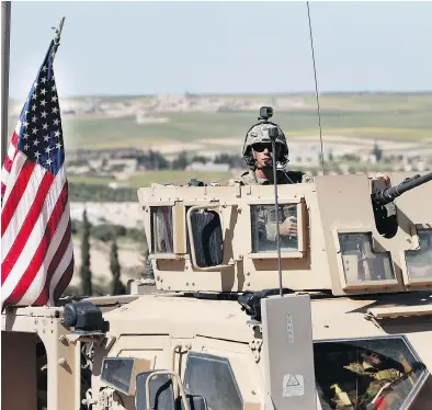  ?? HUSSEIN MALLA / THE ASSOCIATED PRESS ?? A U.S. soldier Wednesday on a road leading to the front line with Turkish-backed fighters, in Manbij, north Syria.