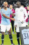  ??  ?? Vincent Kompany makes a presentati­on to Yaya Toure after his final game in a City shirt