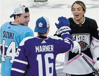  ?? MARTA LAVANDIER THE ASSOCIATED PRESS ?? Montreal’s Nick Suzuki, left, and Toronto’s Mitch Marner congratula­te Sarah Nurse after she scored a goal during the NHL All Star Skills Showcase. Nurse, a Hamilton native, has been offered a position to work with the Florida Panthers’ youth developmen­t program.