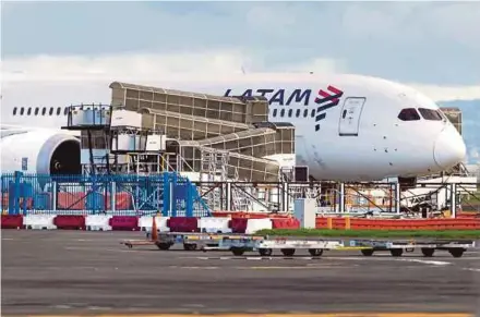  ?? AFP PIC ?? The LATAM Airlines Boeing 787 Dreamliner plane that suddenly lost altitude mid-flight a day earlier, dropping violently and injuring dozens of terrified travellers, is seen on the tarmac of the Auckland Internatio­nal Airport in Auckland yesterday.