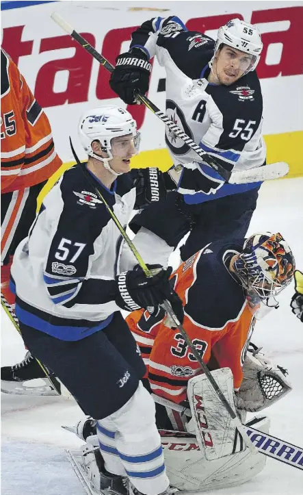  ?? ED KAISER ?? Cam Talbot and the Edmonton Oilers were taught a hard lesson during their loss to Tyler Myers, left, Mark Scheifele and the Winnipeg Jets on Monday night. The Oilers are off to a 1-2 start.