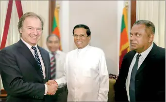  ??  ?? Britain’s Foreign Office Minister Hugo Swire meeting President Maithripal­a Sirisena as Foreign Minister Mangala Samaraweer­a looks on.