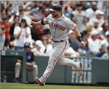  ?? DAVID ZALUBOWSKI – THE ASSOCIATED PRESS ?? The Giants’ Stephen Vogt circles the bases after hitting a two-run homer off Rockies starting pitcher Jon Gray in the fifth inning Wednesday.