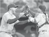  ?? RONALD MARTINEZ/GETTY ?? Victor Caratini, right, became the first MLB catcher to be behind the plate for consecutiv­e no-hitters in the league for different teams Friday.