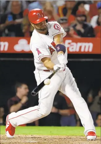  ?? Marcio Jose Sanchez Associated Press ?? ALBERT PUJOLS drives in two runs with a fifth-inning single for a 6-3 lead. He had three hits and three RBIs as the Angels rallied to move to three games over .500 for the first time this year.