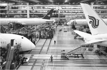  ??  ?? Boeing Dreamliner 787 planes sit on the production line at the company’s final assembly facility in North Charleston, South Carolina, on Dec 6, 2016. — WP-Bloomberg photo