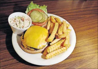  ?? [ANDREA NOALL/DISPATCH] ?? The double cheeseburg­er served with french fries and coleslaw at Jack’s Diner