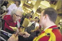  ??  ?? Peabody Duckmaster Anthony Petrina (right) talks with Dorothy Davis as she celebrates her 105th birthday by serving as honorary Duckmaster Friday at The Peabody. Davis is a patient at Crossroads Hospice, which arranged the event — a “Gift of a Day,”...