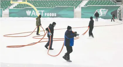  ?? MICHAEL BELL ?? Crews work prepare the enormous skating rink at Mosaic Stadium on Monday with the first public skate scheduled for Dec. 31.