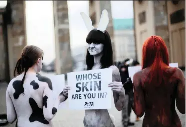  ?? PICTURE: MARKUS SCHREIBER/AP ?? LAID BARE: Peta protesters objecting to the wearing of animal skins. The animal rights group’s sensationa­list and bullying tactics have put it at odds with consumers, scientists and the retail sector.