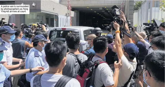  ??  ?? A police van is surrounded by photograph­ers as Tong Ying-kit arrives at court