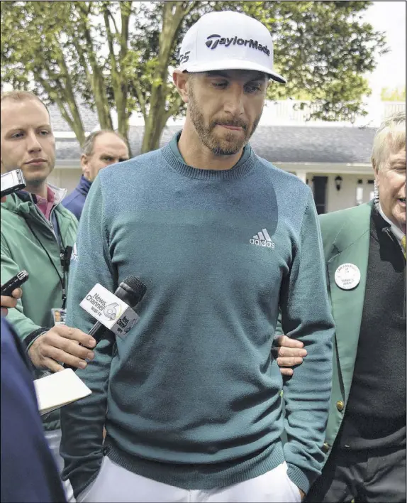  ?? BRANT SANDERLIN / SPECIAL ?? Dustin Johnson talks with the media Thursday after exiting the opening round of the Masters in Augusta. The world’s No. 1-ranked player sustained a back injury less than 24 hours earlier in a freak fall at a home he was renting for the week.