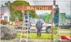  ??  ?? Waimarino Volunteer Rural Fire Force members Pete Pehi (left) and John Chapman (right) install the restored Raetihi sign and plough.