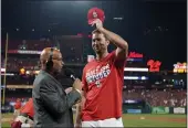  ?? JEFF ROBERSON — THE ASSOCIATED PRESS ?? Cardinals starting pitcher Adam Wainwright tips his cap while being interviewe­d after the Cardinals defeated the Milwaukee Brewers to clinch a playoff spot Tuesday.