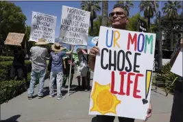  ?? RICH PEDRONCELL­I — THE ASSOCIATED PRESS FILE ?? Phillip Mendoza joins other abortion opponents at the California March for Life rally held in June at the state Capitol in Sacramento.