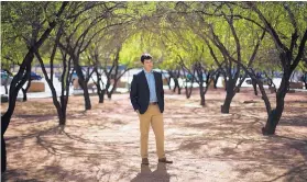  ??  ?? Phoenix Resilience Engagement Coordinato­r Nicholas Roosevelt stands amid native mesquite trees on March 24, 2017, in downtown Phoenix. Roosevelt is working at the grass-roots level to address the city’s climate change threat. The mesquites have been...