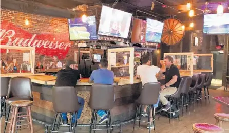  ?? RICH POPE/ORLANDO SENTINEL ½ months ?? Patrons drink at the bar at Stagger Inn in Downtown Orlando on Monday, Sept. 14, 2020 – the first day bars were permitted to serve just alcohol after 2 of being closed because of the coronaviru­s pandemic.